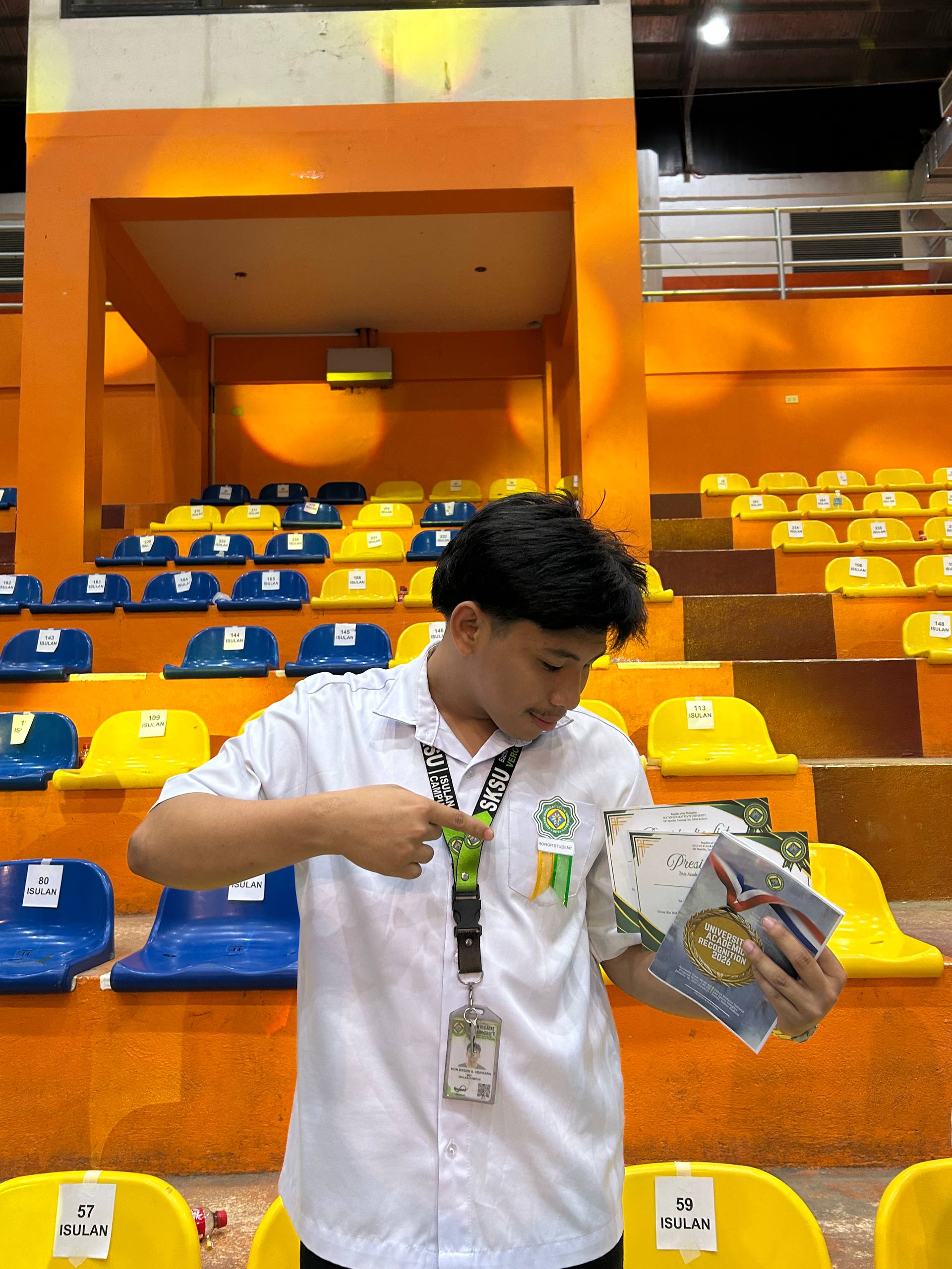 Von showing an academic honor ribbon and recognition certificates